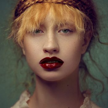 Fine art portrait of a woman with red hair and red lipstick